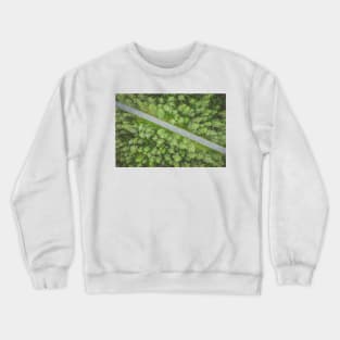 Empty road going diagonally through the forest top down aerial view Crewneck Sweatshirt